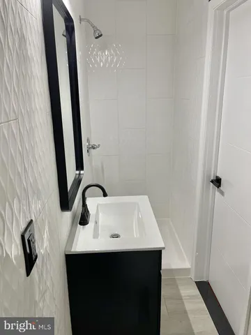 a bathroom with a sink a mirror and vanity