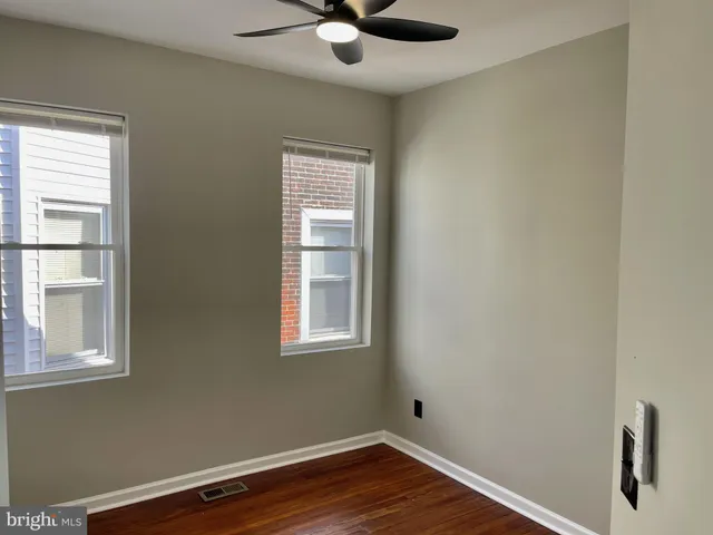 a view of wooden floor and windows in a room