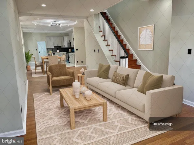 a living room with couches and kitchen view with wooden floor