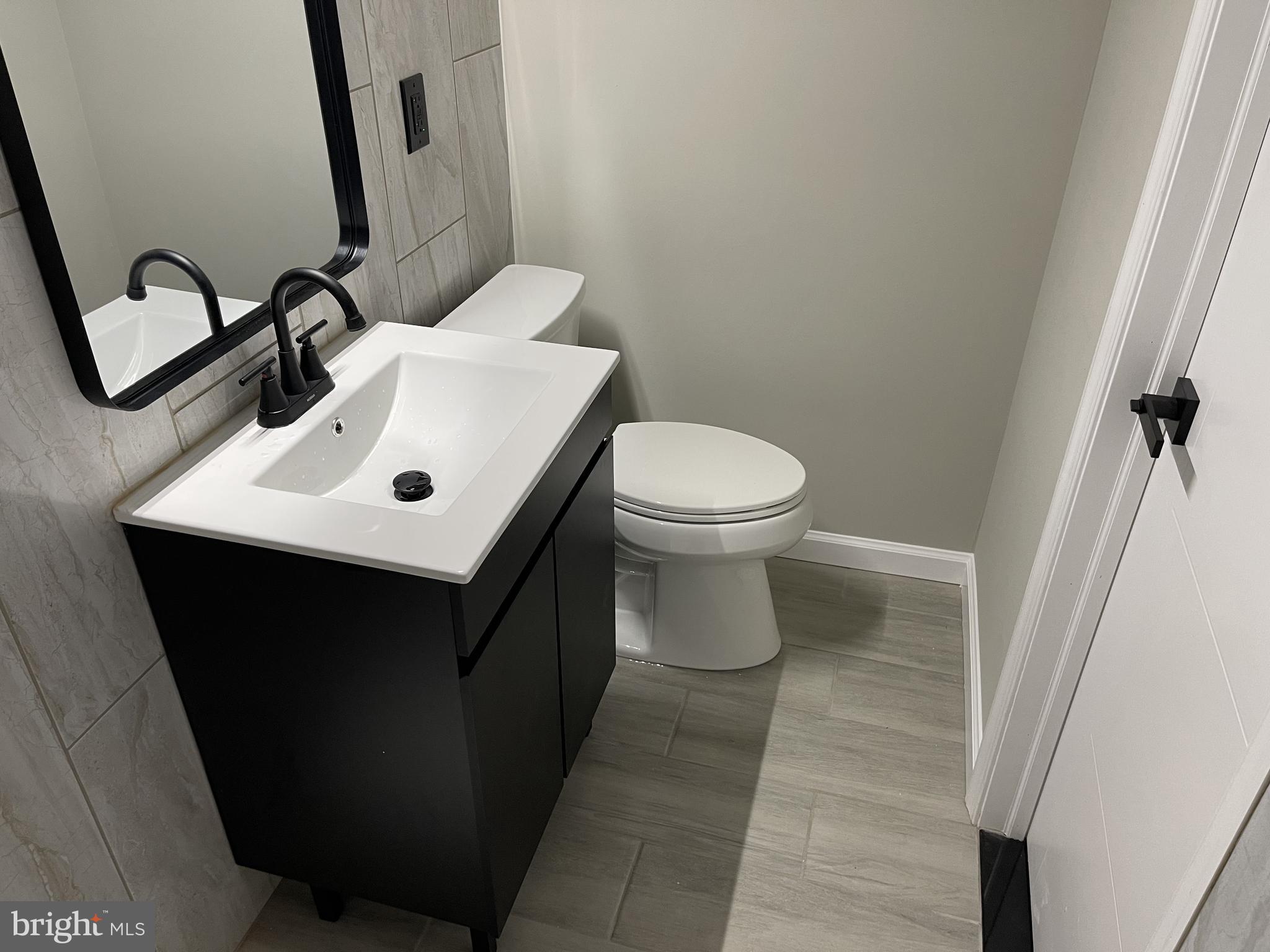 320 West Tabor Road Philadelphia, PA 19120 - Photo 27 of 33 a bathroom with a toilet sink and mirror