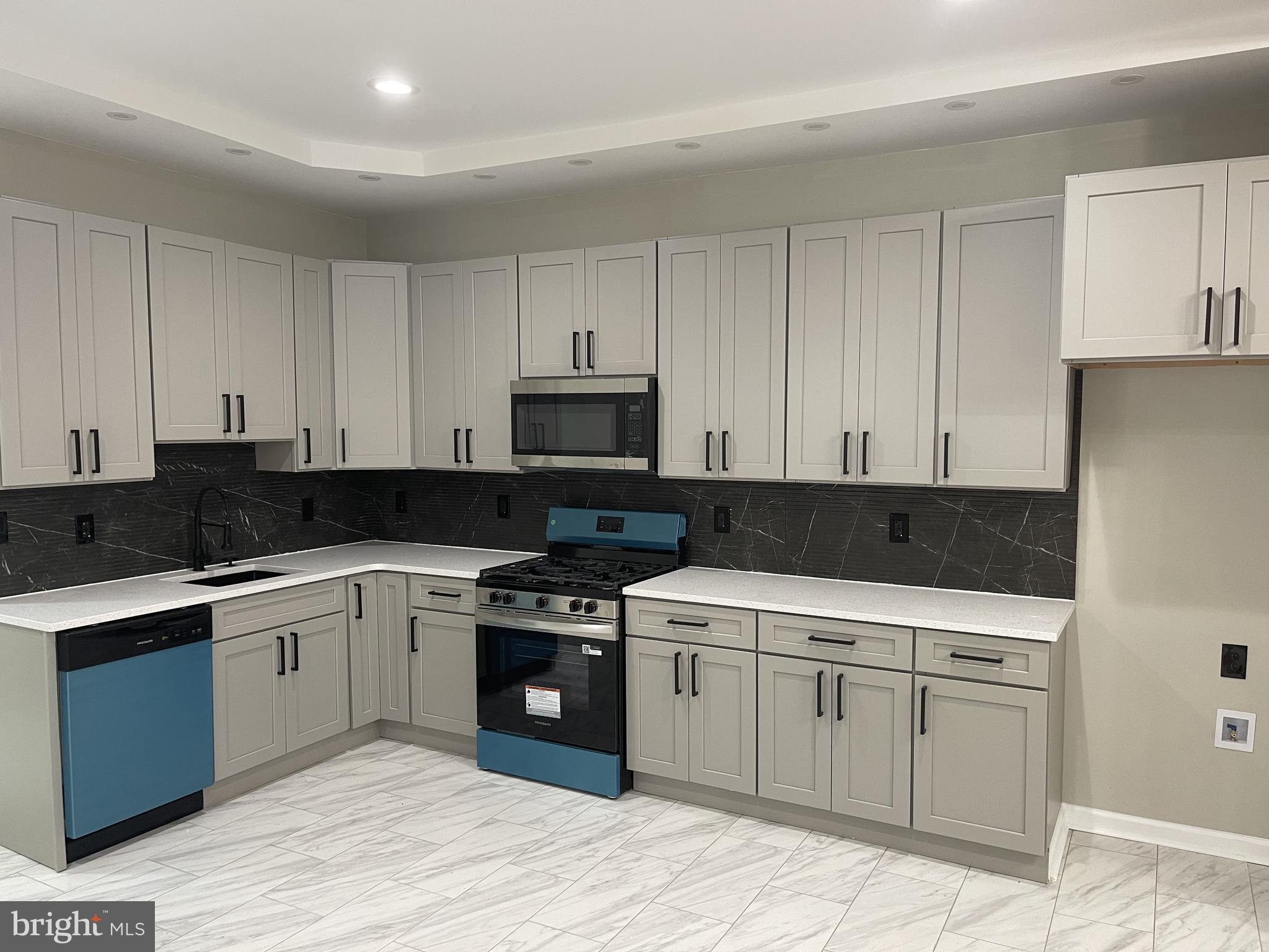 320 West Tabor Road Philadelphia, PA 19120 - Photo 5 of 33 a kitchen with a sink stove and cabinets