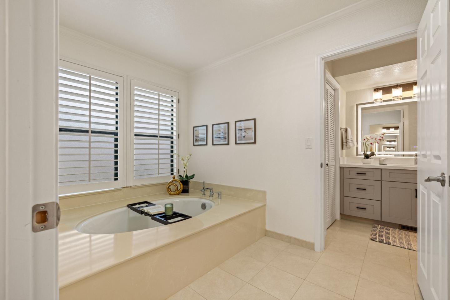 2896 Ransford Avenue Pacific Grove, CA 93950 - Photo 17 of 28 a bathroom with a sink tub vanity and a mirror