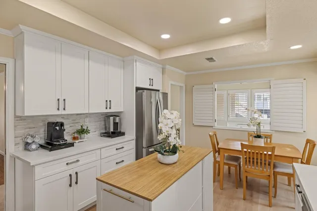a kitchen with a refrigerator and cabinets