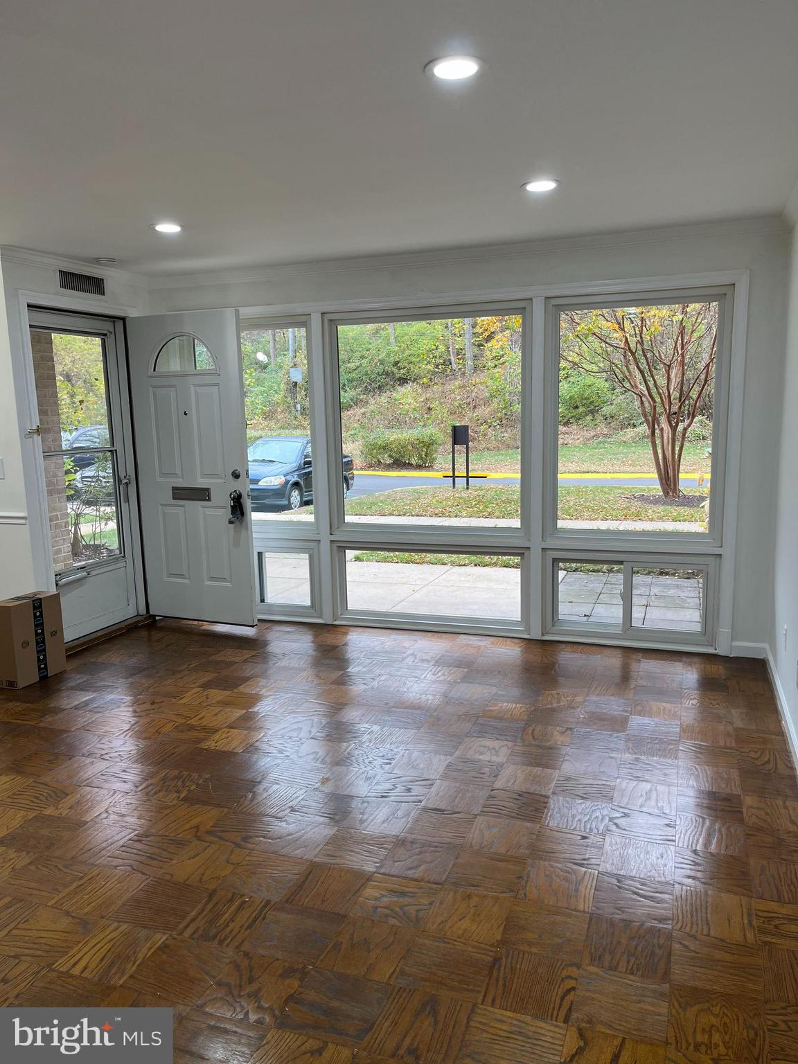 7572 Spring Lake Drive, Unit 7572A Bethesda, MD 20817 - Photo 4 of 7 an empty room with wooden floor and windows
