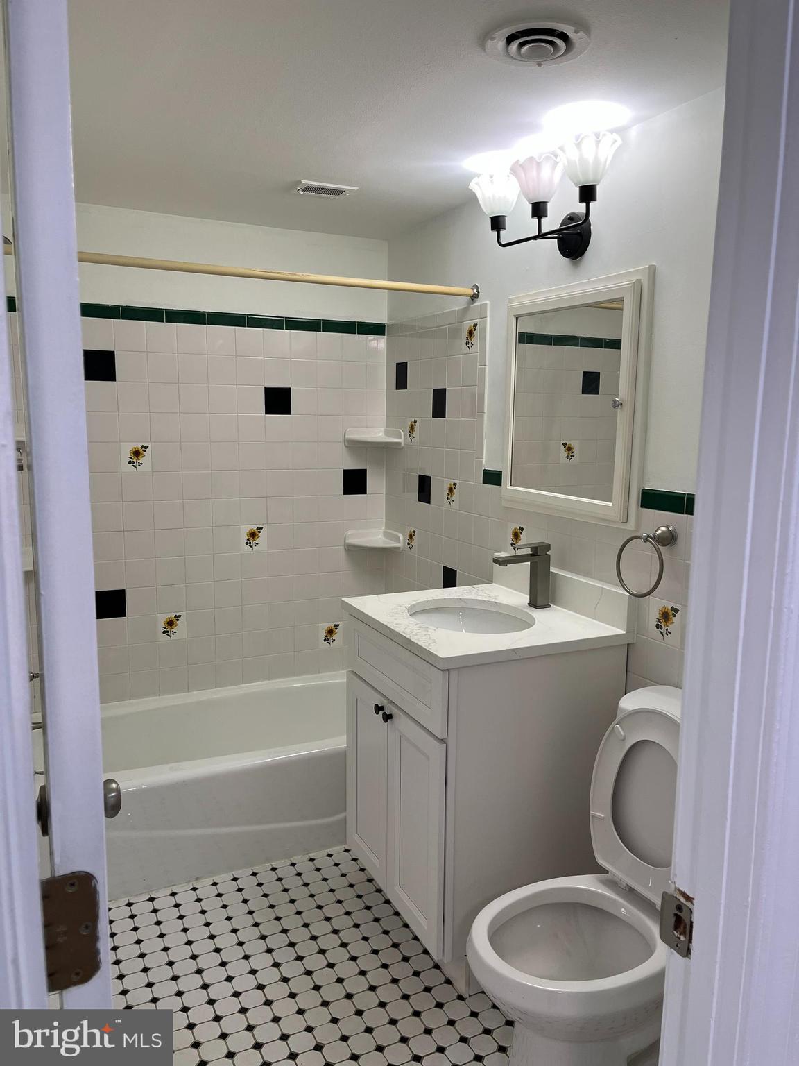 7572 Spring Lake Drive, Unit 7572A Bethesda, MD 20817 - Photo 6 of 7 a bathroom with a sink mirror vanity and toilet
