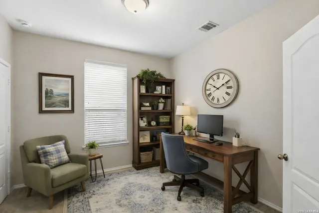 a view of a livingroom with furniture and a window