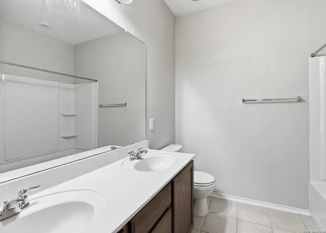 a bathroom with a toilet a sink and a mirror