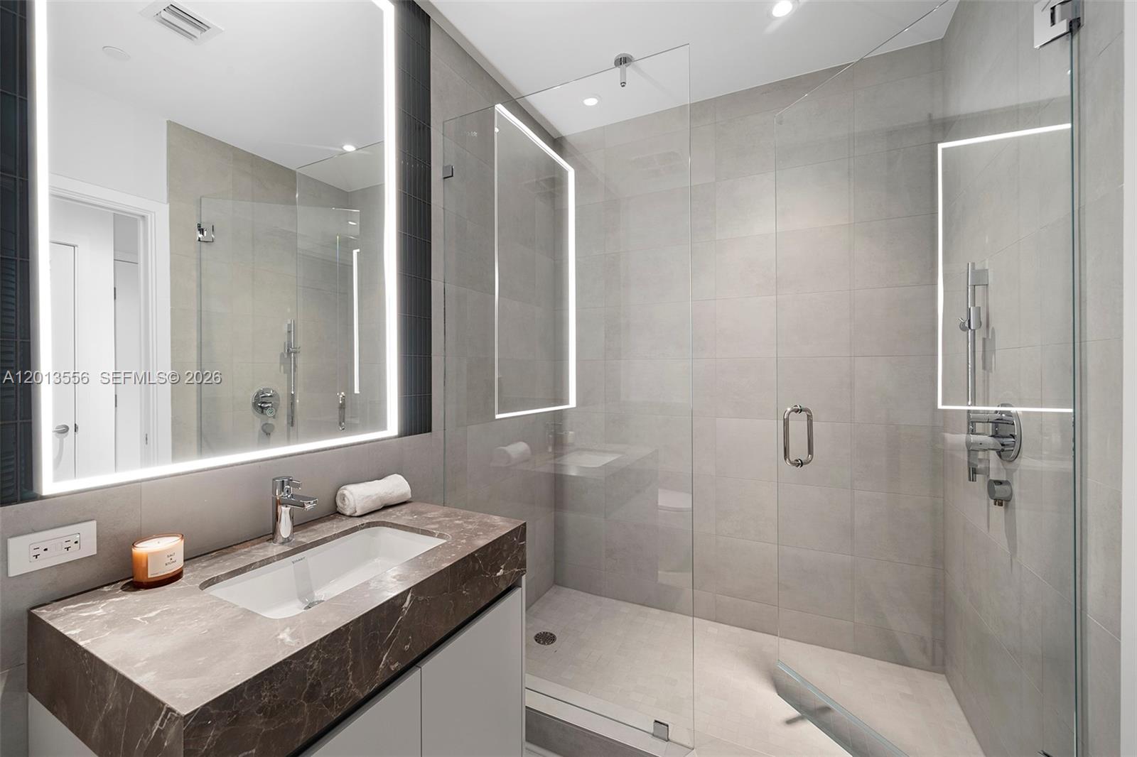 500 Alton Road, Unit 502 Miami Beach, FL 33139 - Photo 9 of 11 a bathroom with a granite countertop sink and a mirror