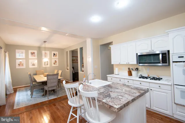 a view of kitchen with cabinets table and chairs