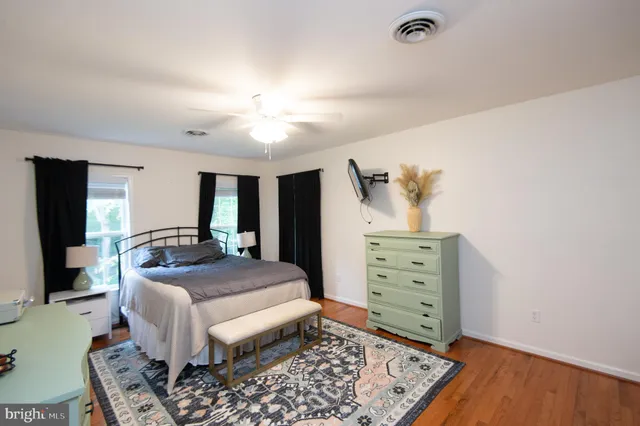 a living room with furniture and a dresser