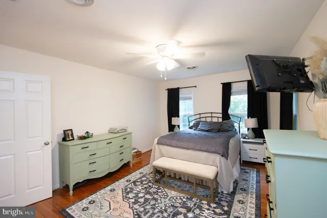 a living room with furniture and a dresser