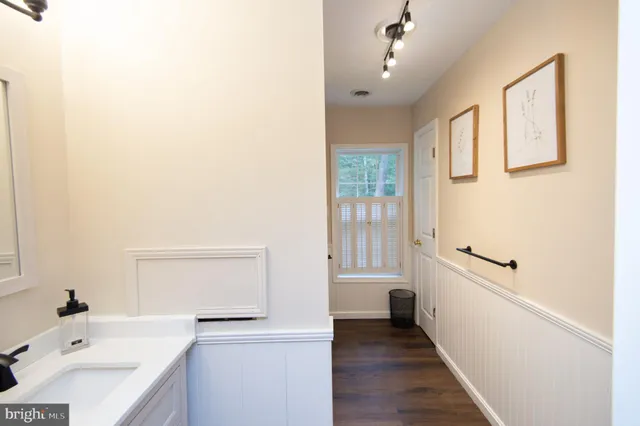 a bathroom with a sink a toilet and a tub