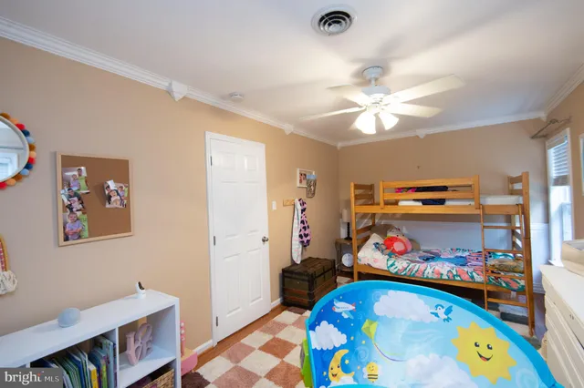 a bedroom with furniture and a baby crib
