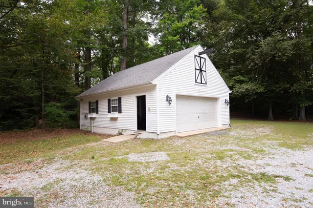 a front view of house with yard and trees