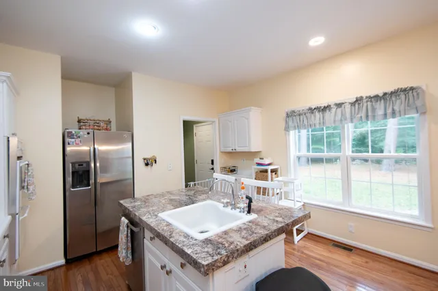 a kitchen with granite countertop a stove and a refrigerator