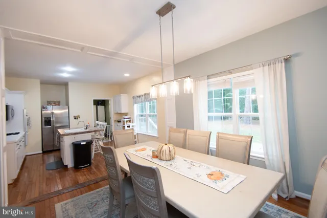 a large white kitchen with a table and chairs