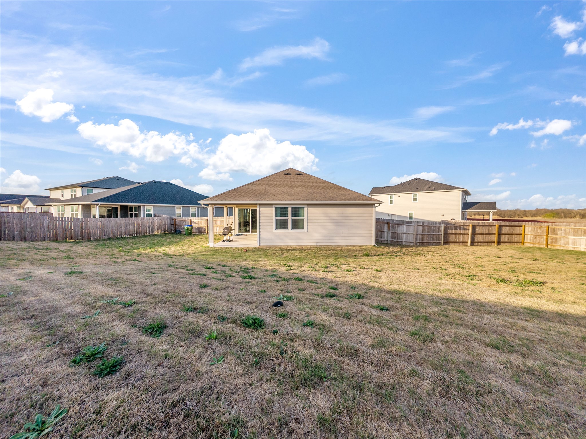 20811 Phebe Foster Street Manor, TX 78653 - Photo 29 of 40 Back of house with a patio area and a fenced backyard