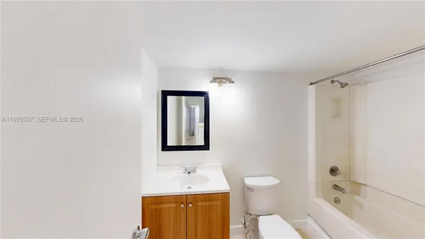 a bathroom with a toilet sink shower and mirror