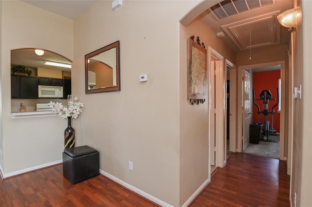 18446 South Wimbledon Drive Katy, TX 77449 - Photo 2 of 24 a view of a hallway with wooden floor and cabinet
