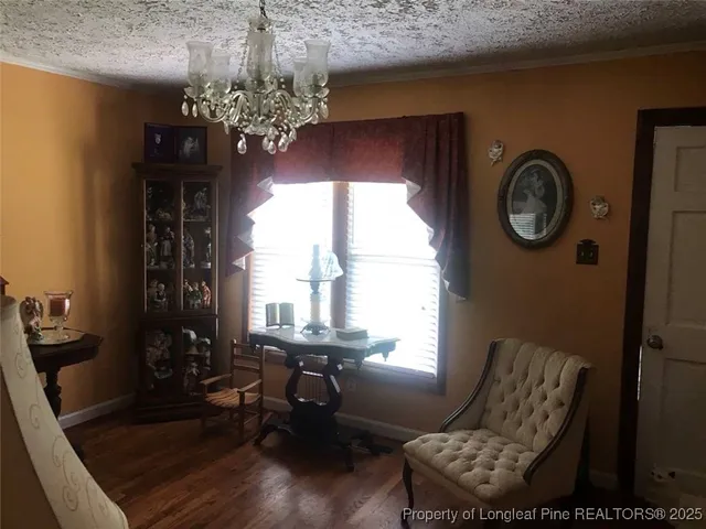 a view of hall way with furniture and a chandelier