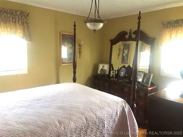 a bedroom with a bed and a mirror