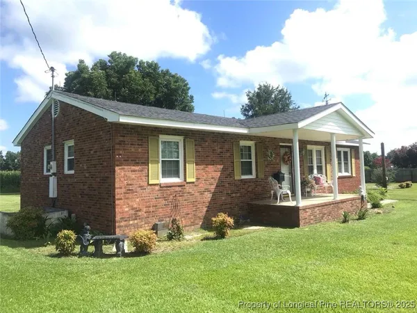 a front view of a house with a yard and porch