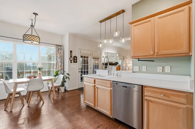 a open kitchen with granite countertop a stove and white cabinets