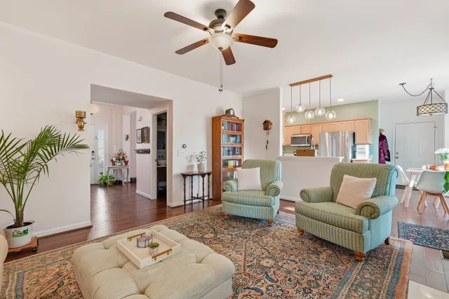 a living room with furniture and a chandelier