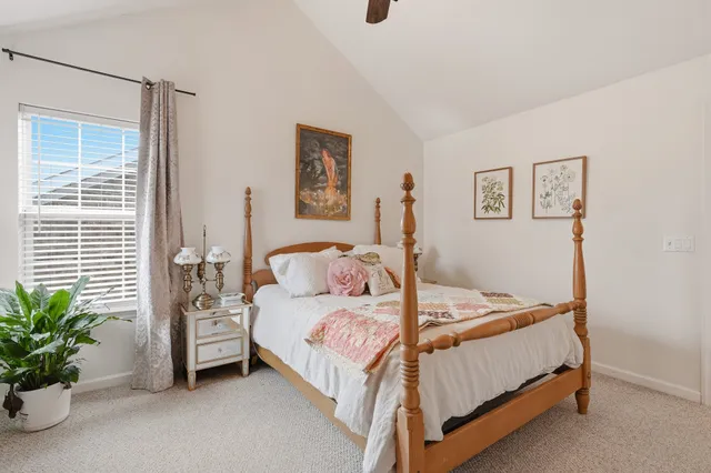 a bedroom with a bed and a potted plant