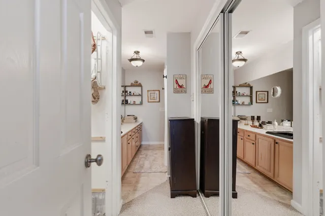 a kitchen with cabinets and refrigerator