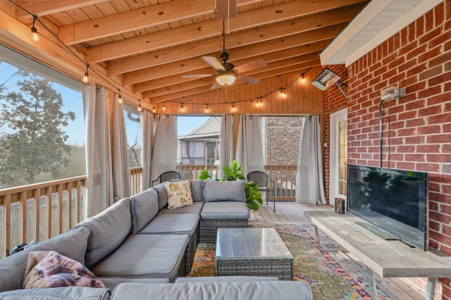 a balcony with furniture and a fireplace