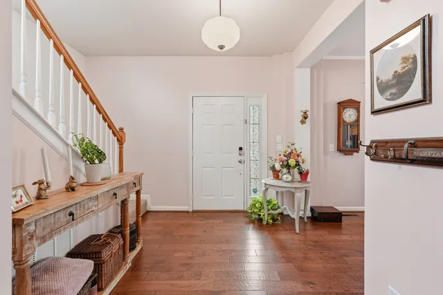 a view of an entryway with wooden floor