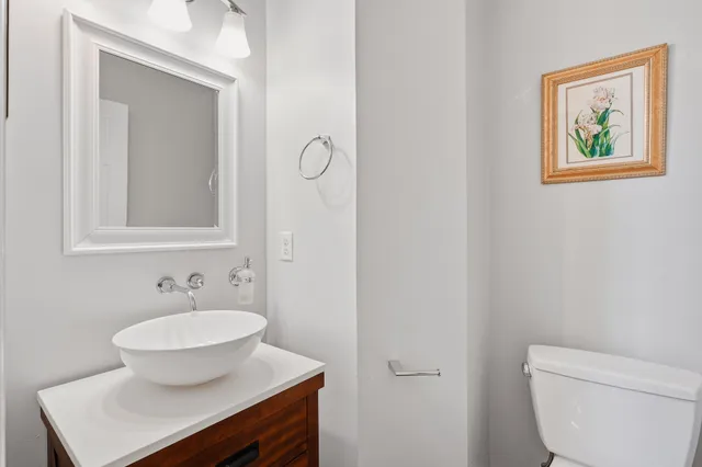a bathroom with a toilet a sink and mirror
