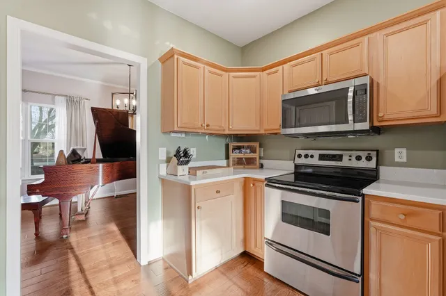 a kitchen with stainless steel appliances granite countertop a stove microwave and cabinets