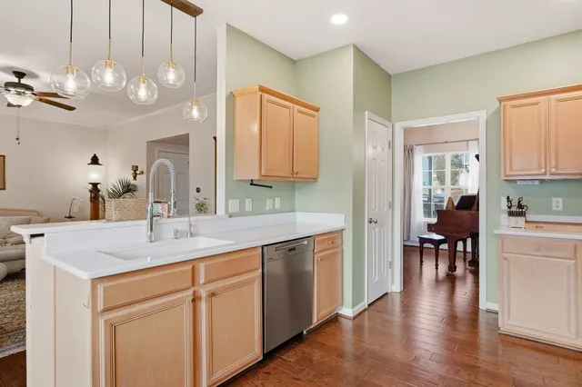 a view of a hallway that has a dining table and chairs in it