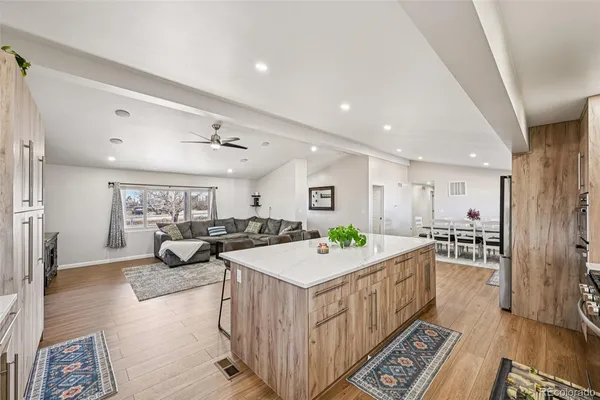 a living room with furniture a wooden floor and next to a window