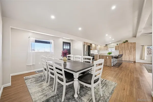a living room with furniture and a view of kitchen