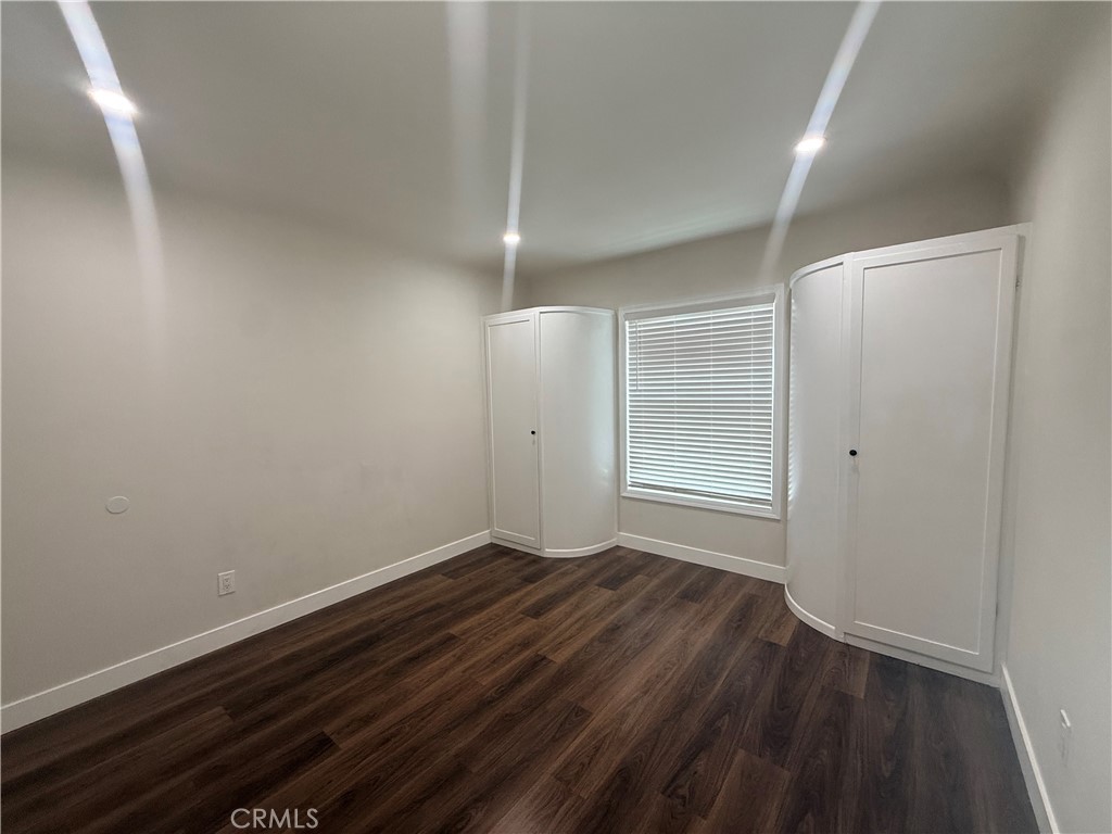 3688 Taft Street Riverside, CA 92503 - Photo 13 of 15 a view of an empty room with wooden floor and a window