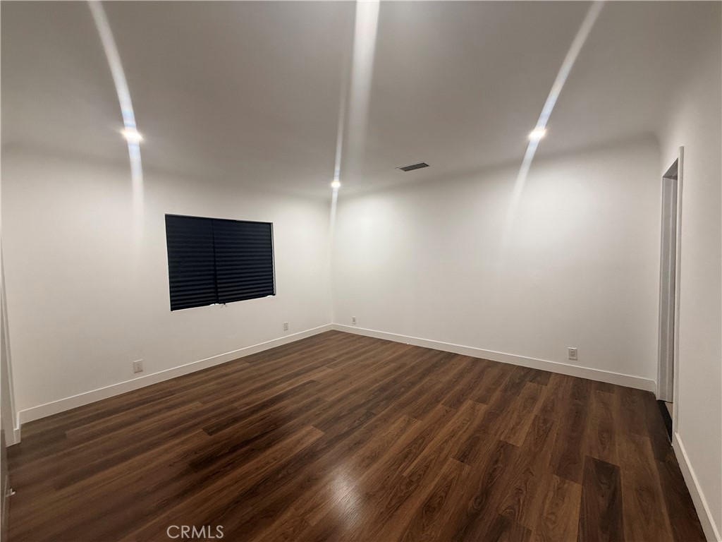 3688 Taft Street Riverside, CA 92503 - Photo 8 of 15 an empty room with wooden floor and windows