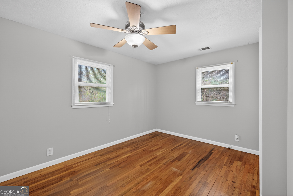 11 Johnston Road Griffin, GA 30224 - Photo 19 of 46 wooden floor in an empty room with a window