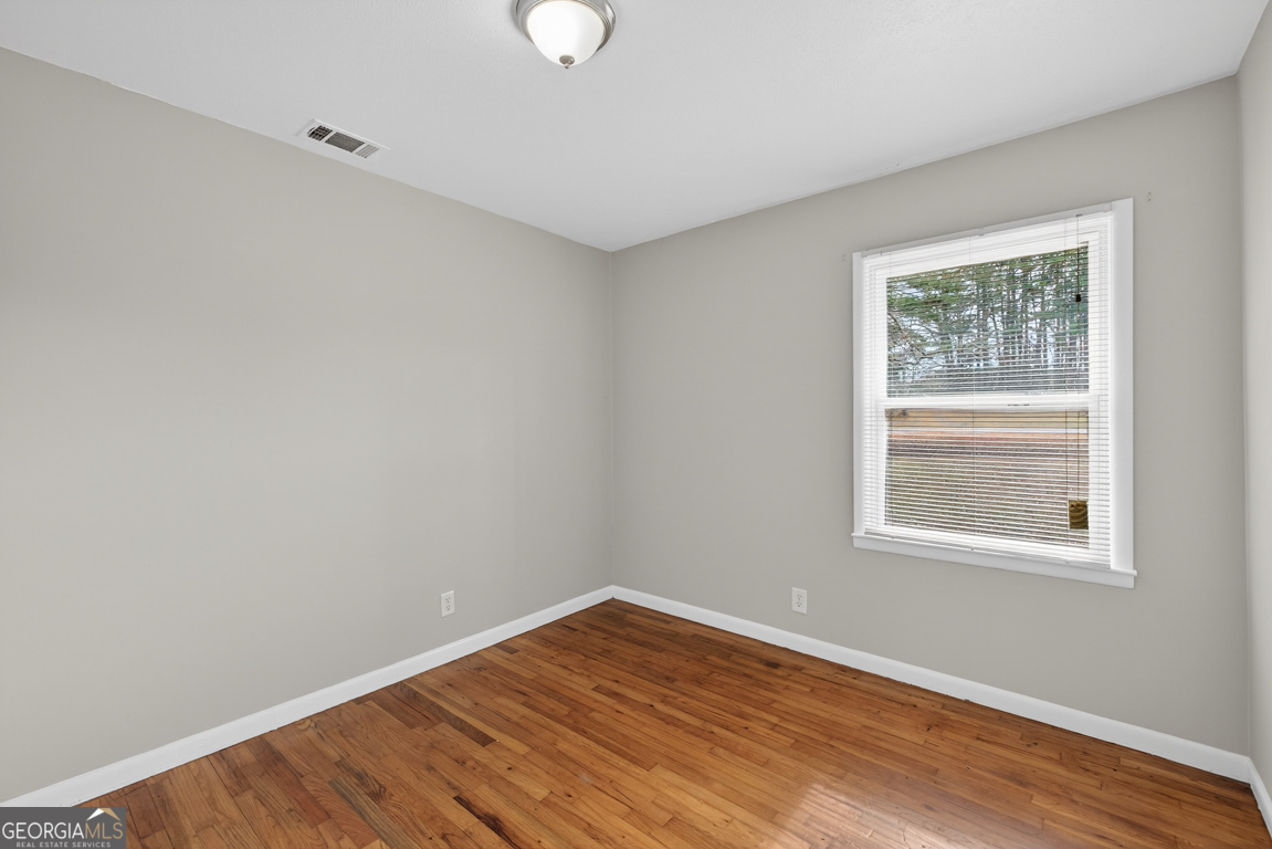 11 Johnston Road Griffin, GA 30224 - Photo 22 of 46 an empty room with wooden floor and windows