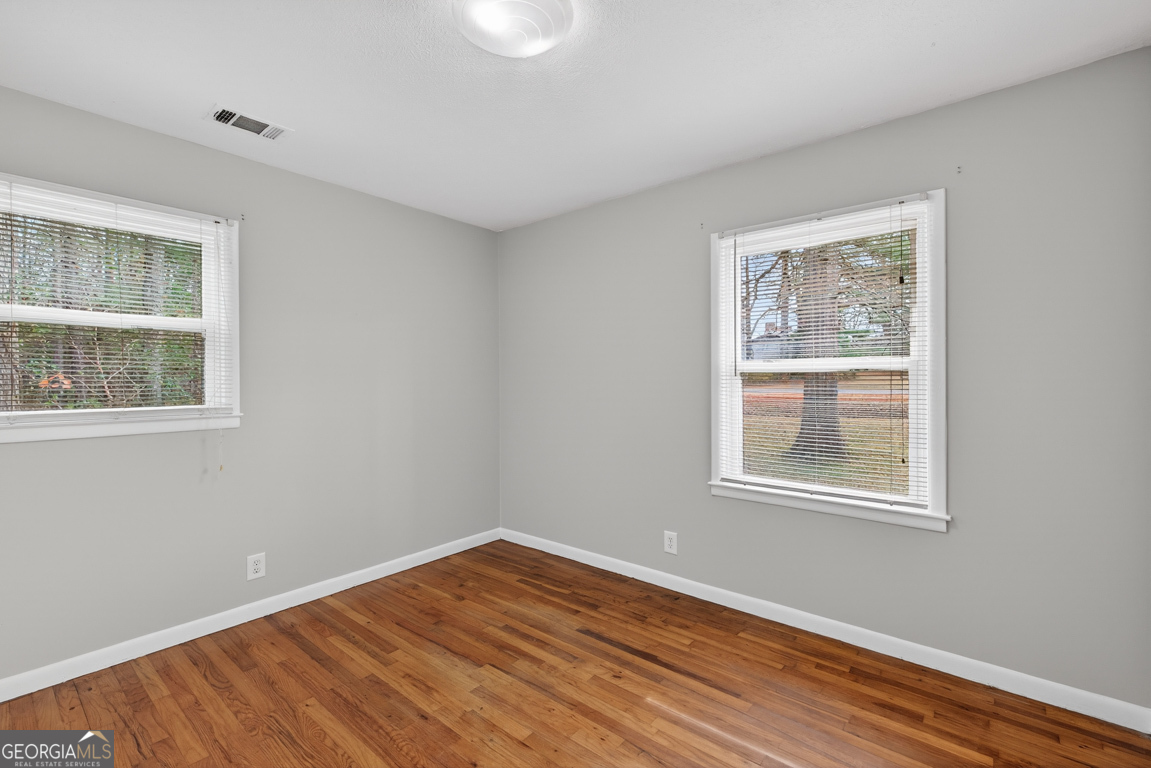11 Johnston Road Griffin, GA 30224 - Photo 27 of 46 a view of an empty room with wooden floor and a window