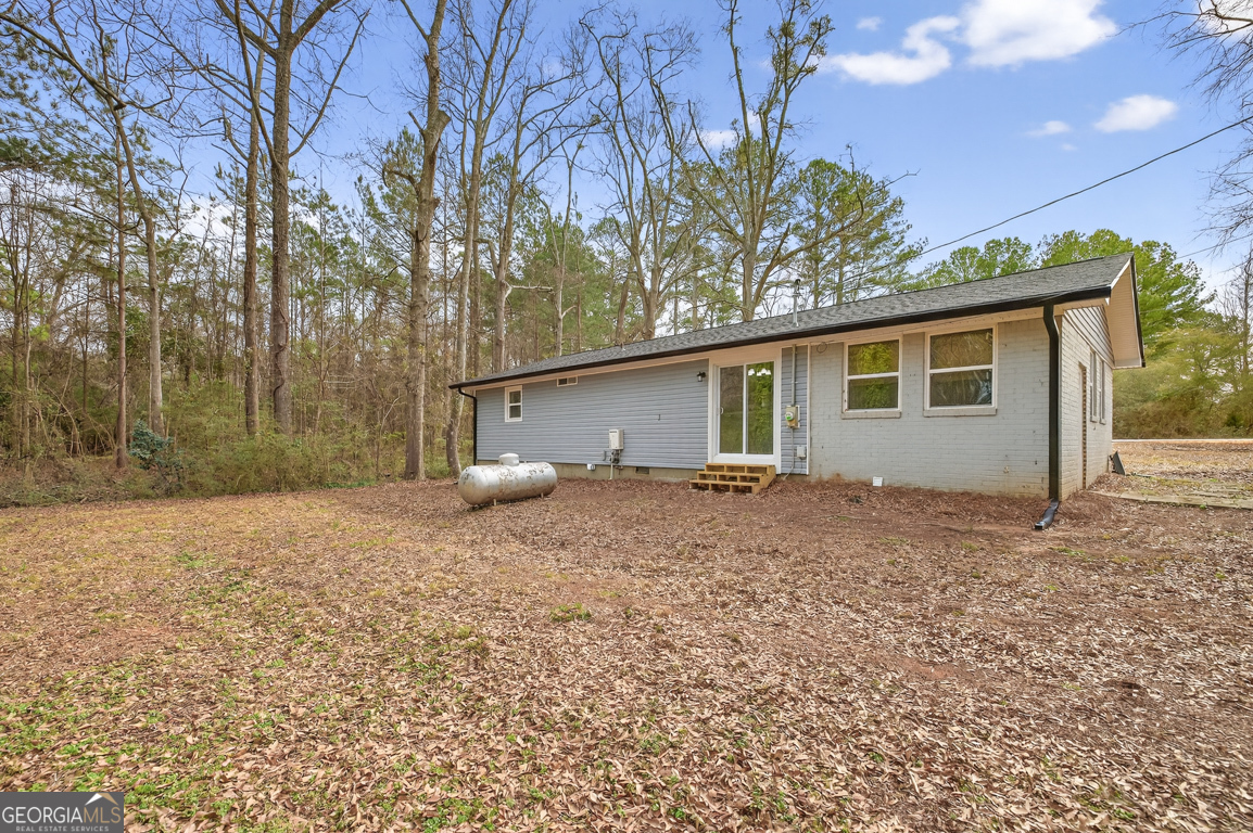 11 Johnston Road Griffin, GA 30224 - Photo 35 of 46 a backyard of a house with large trees and outdoor space