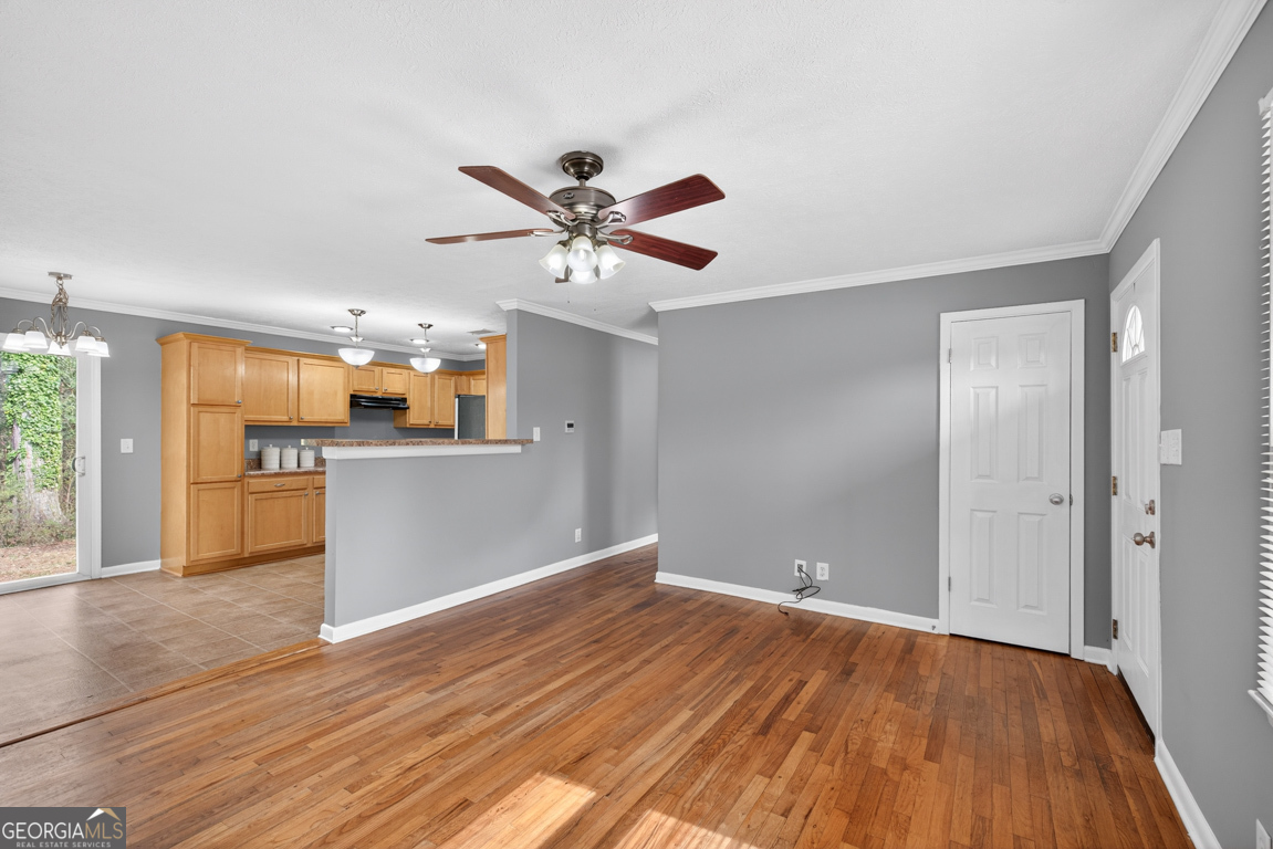 11 Johnston Road Griffin, GA 30224 - Photo 5 of 46 a view of a kitchen with wooden floor and a ceiling fan