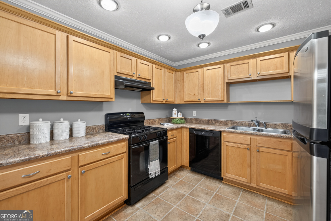 11 Johnston Road Griffin, GA 30224 - Photo 8 of 46 a kitchen with stainless steel appliances granite countertop a stove sink and cabinets