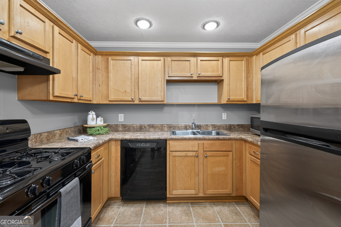 11 Johnston Road Griffin, GA 30224 - Photo 9 of 46 a kitchen with stainless steel appliances granite countertop a stove sink and cabinets