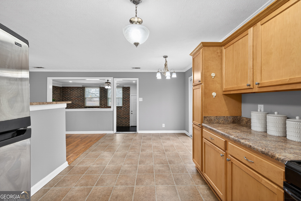 11 Johnston Road Griffin, GA 30224 - Photo 10 of 46 a large kitchen with granite countertop a large counter top space appliances and cabinets