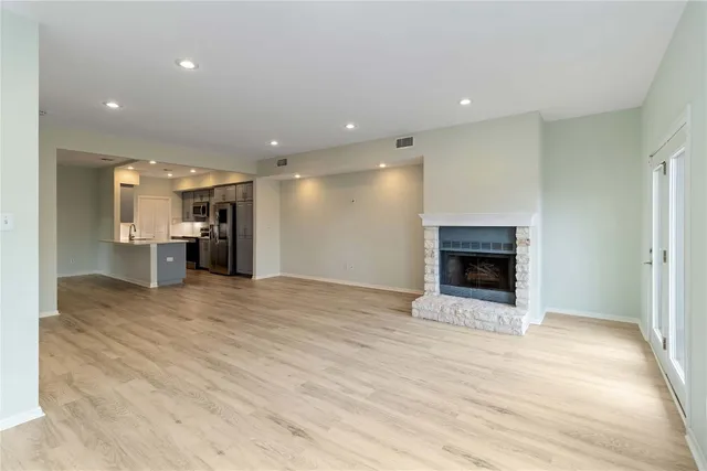 a view of an empty room and a fireplace