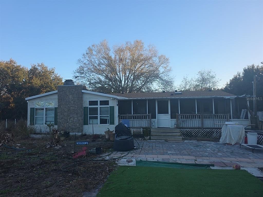 31244 Tyndall Road Zephyrhills, FL 33545 - Photo 1 of 24 a view of house with backyard and garden