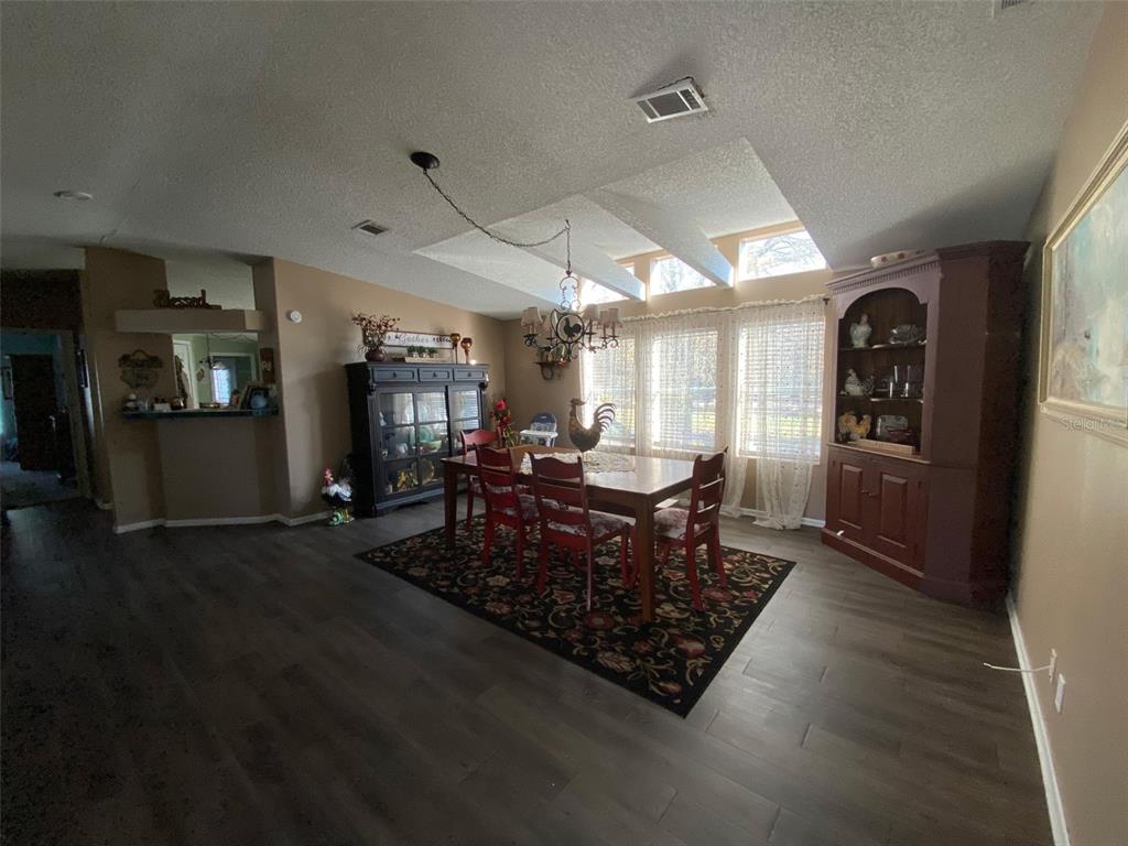 31244 Tyndall Road Zephyrhills, FL 33545 - Photo 2 of 24 a living room with furniture a rug and a window